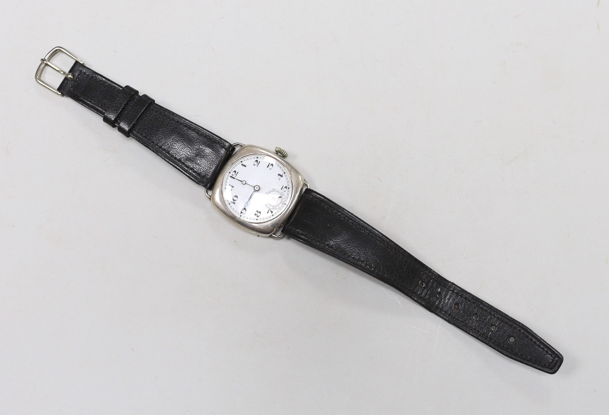 A gentleman's 1920's silver manual wind wrist watch, with Arabic dial and subsidiary seconds, on a later leather strap.